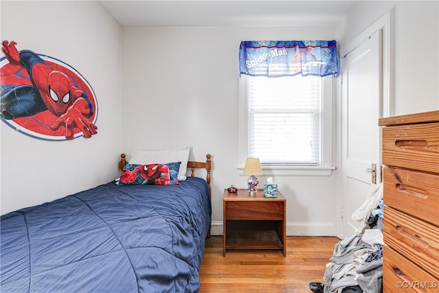 18 E 36th St, Richmond, VA 23224 - bedroom with light wood-style floors and a baseboard radiator