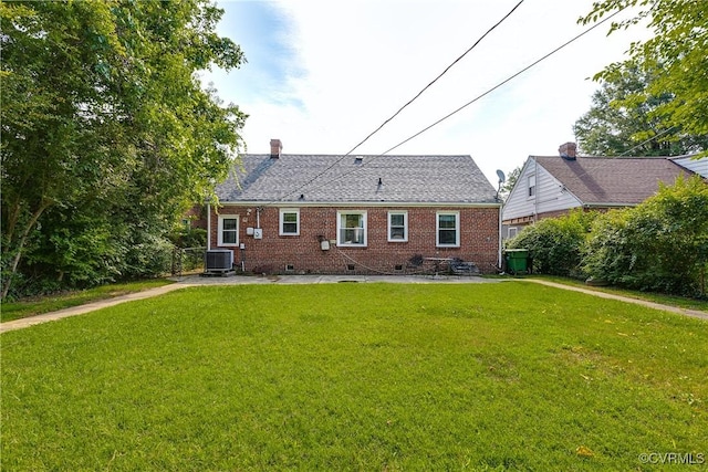 18 E 36th St, Richmond, VA 23224 - rear view of property featuring crawl space, a yard, brick siding, and a chimney