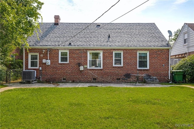 18 E 36th St, Richmond, VA 23224 - rear view of property with roof with shingles, a lawn, and a chimney