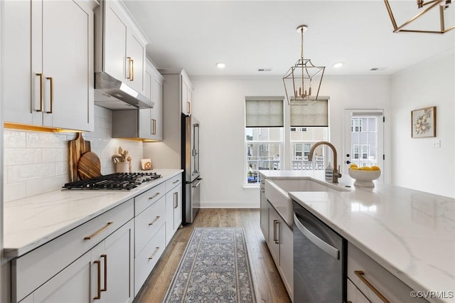 6988 Leire Ln, Chesterfield, VA 23832 - kitchen featuring stainless steel appliances, healthy amount of natural light, backsplash, hanging light fixtures, and recessed lighting
