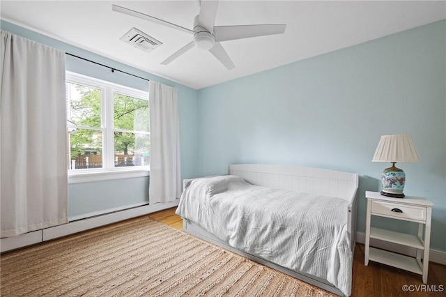 8507 Hanford Dr, Henrico, VA 23229 - bedroom with a baseboard heating unit, wood finished floors, and a ceiling fan