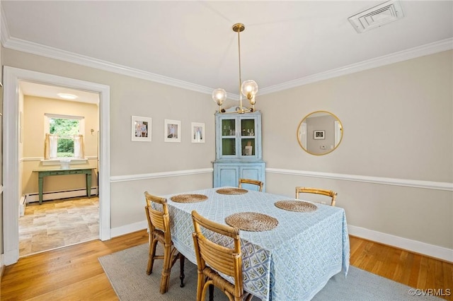 8507 Hanford Dr, Henrico, VA 23229 - dining space with a baseboard heating unit, ornamental molding, and wood finished floors
