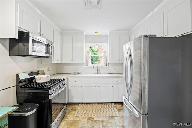 8507 Hanford Dr, Henrico, VA 23229 - kitchen featuring appliances with stainless steel finishes, white cabinets, light countertops, and crown molding