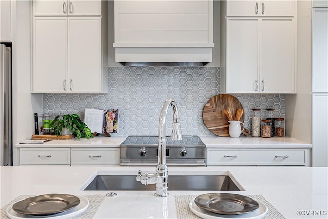 1823 W Cary St Unit A, Richmond, VA 23220 - kitchen featuring light countertops, white cabinets, tasteful backsplash, and premium range hood