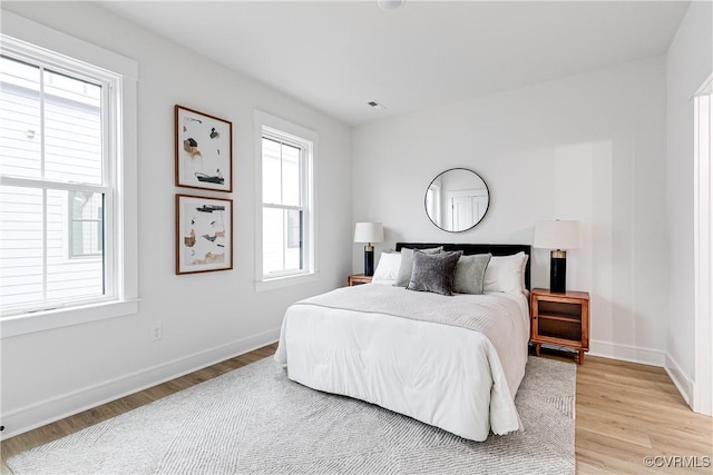 1823 W Cary St Unit A, Richmond, VA 23220 - bedroom with multiple windows and light wood-style floors