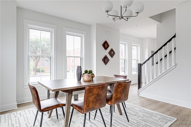 1823 W Cary St Unit A, Richmond, VA 23220 - dining area featuring a chandelier, light wood-style flooring, and stairway