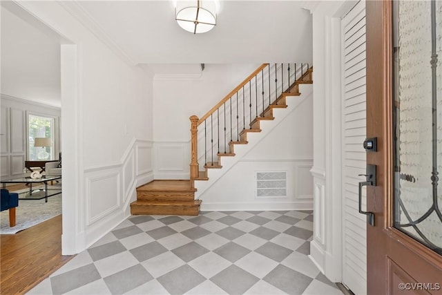 13511 W Salisbury Rd, Chesterfield, VA 23113 - entryway with light floors, stairs, a decorative wall, and wainscoting