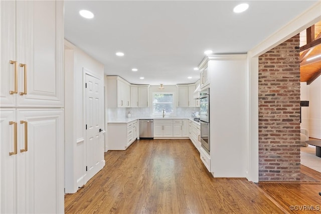 13511 W Salisbury Rd, Chesterfield, VA 23113 - kitchen featuring dishwasher, light wood-style floors, tasteful backsplash, light countertops, and recessed lighting