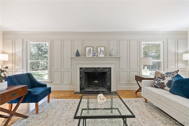 13511 W Salisbury Rd, Chesterfield, VA 23113 - living room with a decorative wall, plenty of natural light, light wood-style flooring, a fireplace, and crown molding