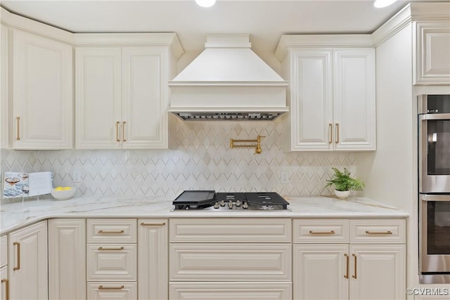 13511 W Salisbury Rd, Chesterfield, VA 23113 - kitchen featuring premium range hood, appliances with stainless steel finishes, light stone countertops, white cabinets, and decorative backsplash