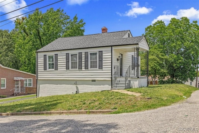 1505 Floyd St, Petersburg, VA 23803 - view of front of property with a chimney, a shingled roof, and a front yard