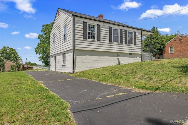 1505 Floyd St, Petersburg, VA 23803 - view of home's exterior with a chimney and a lawn
