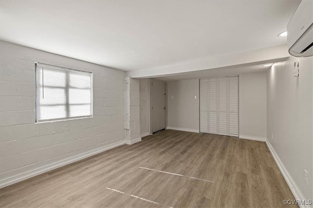 1505 Floyd St, Petersburg, VA 23803 - unfurnished bedroom with wood finished floors and a wall unit AC
