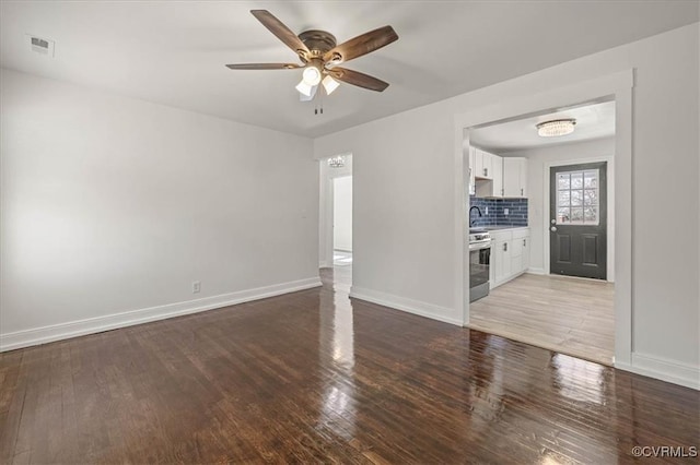 1505 Floyd St, Petersburg, VA 23803 - unfurnished living room with light wood-style flooring and a ceiling fan