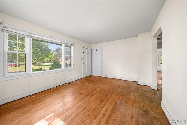 414 John St, Ashland, VA 23005 - unfurnished room featuring arched walkways and wood finished floors