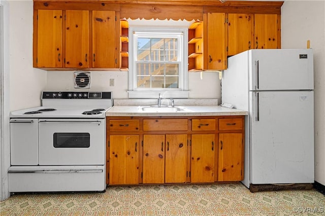 414 John St, Ashland, VA 23005 - kitchen featuring white appliances, open shelves, light countertops, and brown cabinets