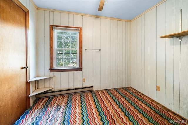414 John St, Ashland, VA 23005 - spare room featuring wooden walls, a baseboard radiator, and carpet