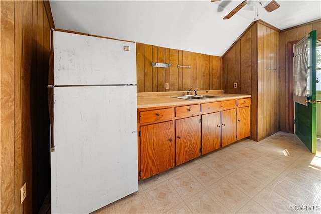 414 John St, Ashland, VA 23005 - kitchen with freestanding refrigerator, wooden walls, a ceiling fan, vaulted ceiling, and light countertops