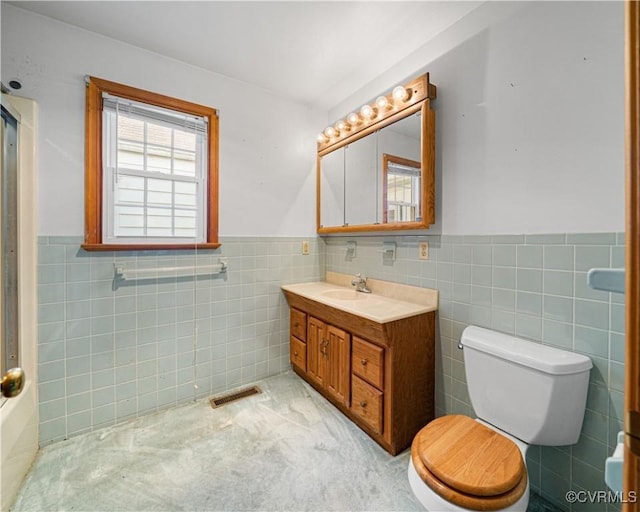 414 John St, Ashland, VA 23005 - full bathroom with tile walls, a wainscoted wall, vanity, and a shower