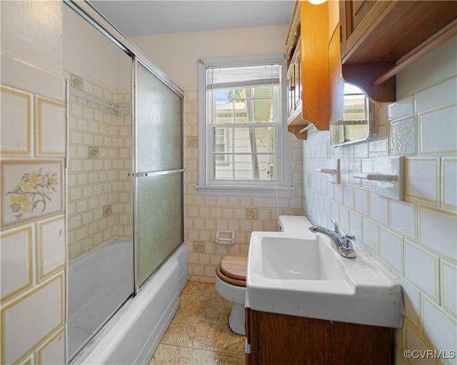 414 John St, Ashland, VA 23005 - bathroom featuring tile walls, combined bath / shower with glass door, plenty of natural light, vanity, and tile patterned floors