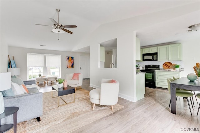 4814 Mill Park Ct, Glen Allen, VA 23060 - living area featuring vaulted ceiling, ceiling fan, and light wood-style flooring