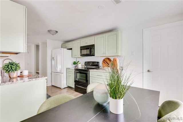 4814 Mill Park Ct, Glen Allen, VA 23060 - kitchen featuring black appliances, backsplash, light wood-style floors, and light stone counters