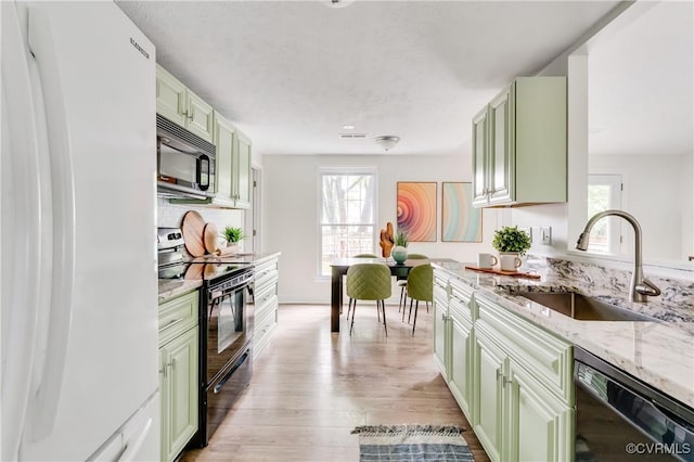 4814 Mill Park Ct, Glen Allen, VA 23060 - kitchen featuring black appliances, green cabinets, light stone countertops, and light wood-style flooring