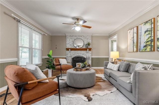 14106 Pensive Pl, Midlothian, VA 23112 - living area featuring plenty of natural light, wood finished floors, a ceiling fan, a fireplace, and a wainscoted wall