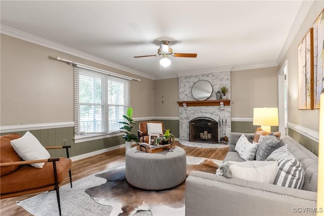 14106 Pensive Pl, Midlothian, VA 23112 - living area with wood finished floors, a fireplace, a wainscoted wall, a ceiling fan, and crown molding