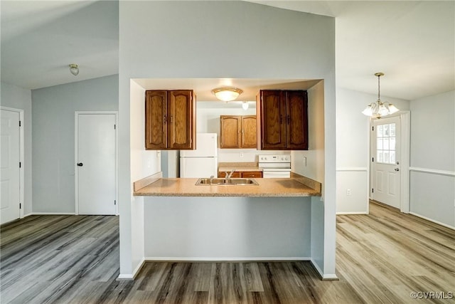 7131 Brook Way, Mechanicsville, VA 23111 - kitchen with white appliances, wood finished floors, lofted ceiling, a chandelier, and light countertops