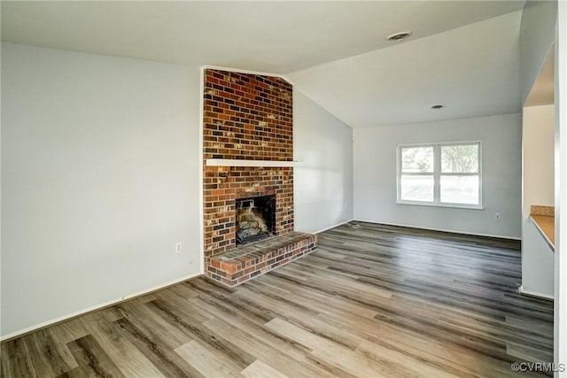 7131 Brook Way, Mechanicsville, VA 23111 - unfurnished living room featuring wood finished floors, vaulted ceiling, and a fireplace