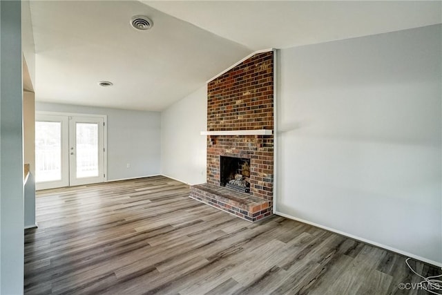 7131 Brook Way, Mechanicsville, VA 23111 - unfurnished living room with wood finished floors, lofted ceiling, a brick fireplace, and french doors