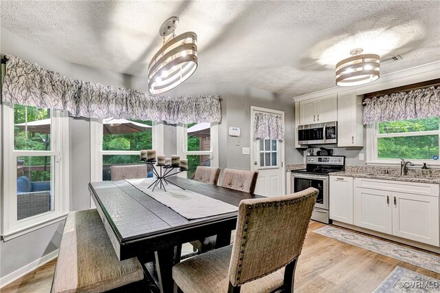 7100 Deer Thicket Dr, Midlothian, VA 23112 - dining room with a textured ceiling and light wood-style floors