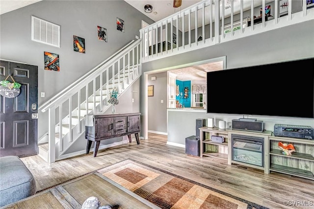 7100 Deer Thicket Dr, Midlothian, VA 23112 - living area with stairway, a high ceiling, and wood finished floors