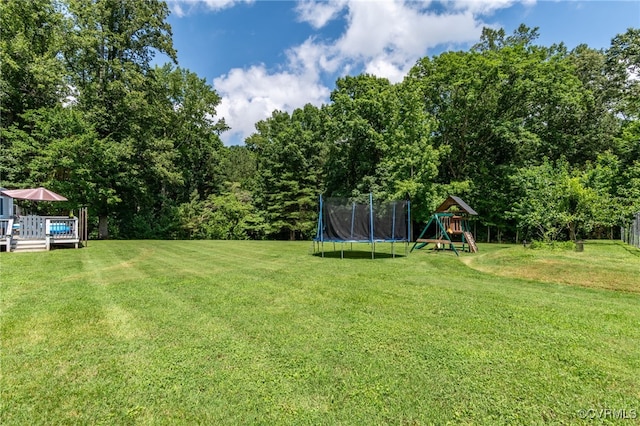 12900 Spring Run Rd, Midlothian, VA 23112 - view of green lawn with a trampoline, a playground, and a wooden deck