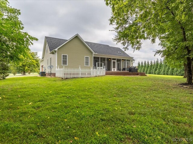 1130 Sparrows Ln, Powhatan, VA 23139 - back of property with a sunroom, a yard, and roof with shingles