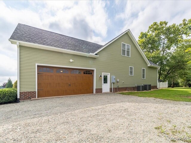 1130 Sparrows Ln, Powhatan, VA 23139 - view of home's exterior featuring gravel driveway, roof with shingles, and a garage
