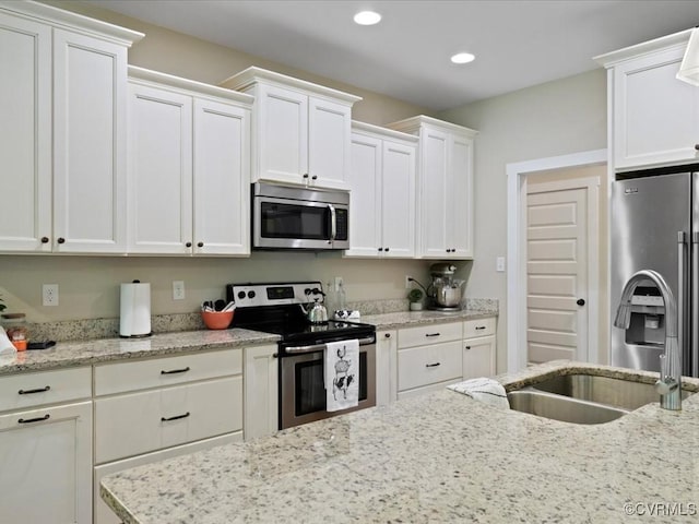 1130 Sparrows Ln, Powhatan, VA 23139 - kitchen with appliances with stainless steel finishes, white cabinetry, recessed lighting, and light stone counters
