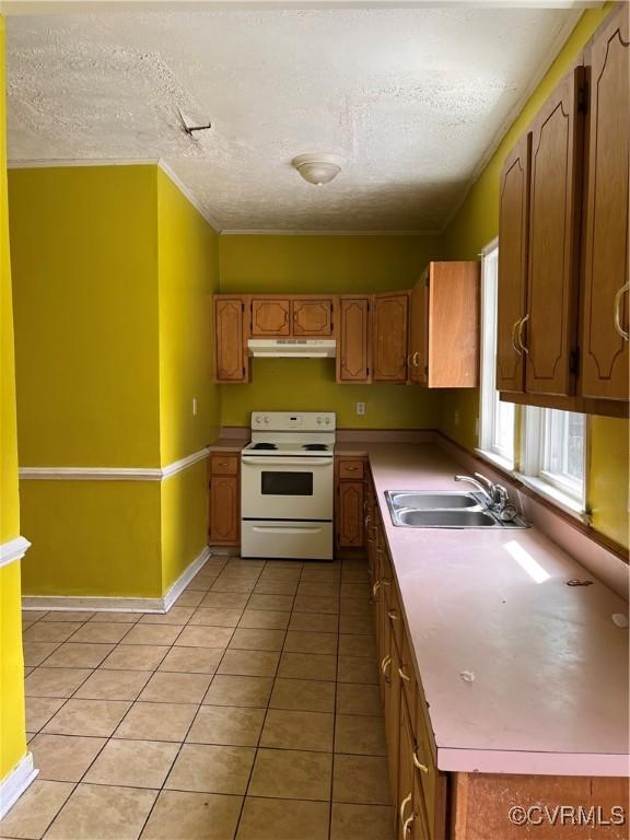 2214 2nd Ave, Richmond, VA 23222 - kitchen featuring electric range, under cabinet range hood, a textured ceiling, light tile patterned floors, and light countertops