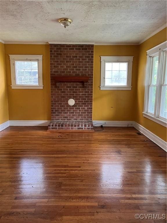 2214 2nd Ave, Richmond, VA 23222 - unfurnished living room with ornamental molding, a textured ceiling, hardwood / wood-style flooring, and plenty of natural light