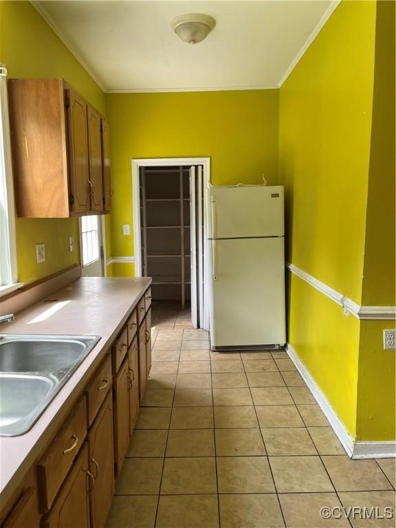 2214 2nd Ave, Richmond, VA 23222 - kitchen with freestanding refrigerator, light tile patterned floors, and crown molding