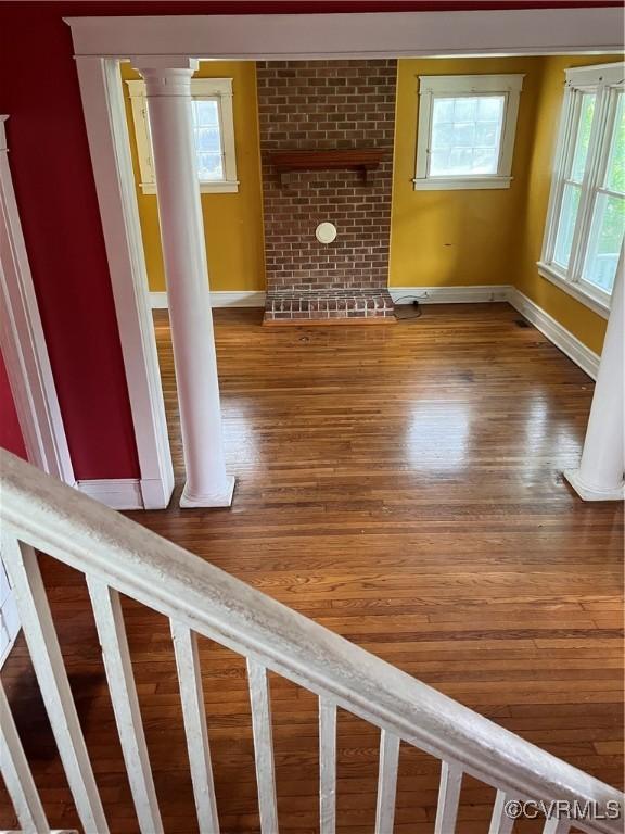 2214 2nd Ave, Richmond, VA 23222 - unfurnished living room with healthy amount of natural light, wood finished floors, and ornate columns