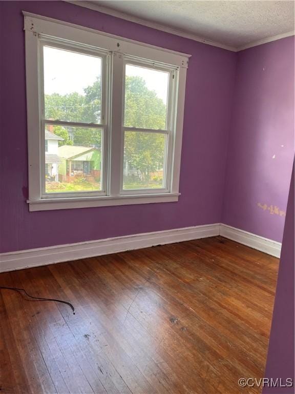 2214 2nd Ave, Richmond, VA 23222 - spare room featuring hardwood / wood-style floors, a textured ceiling, and ornamental molding