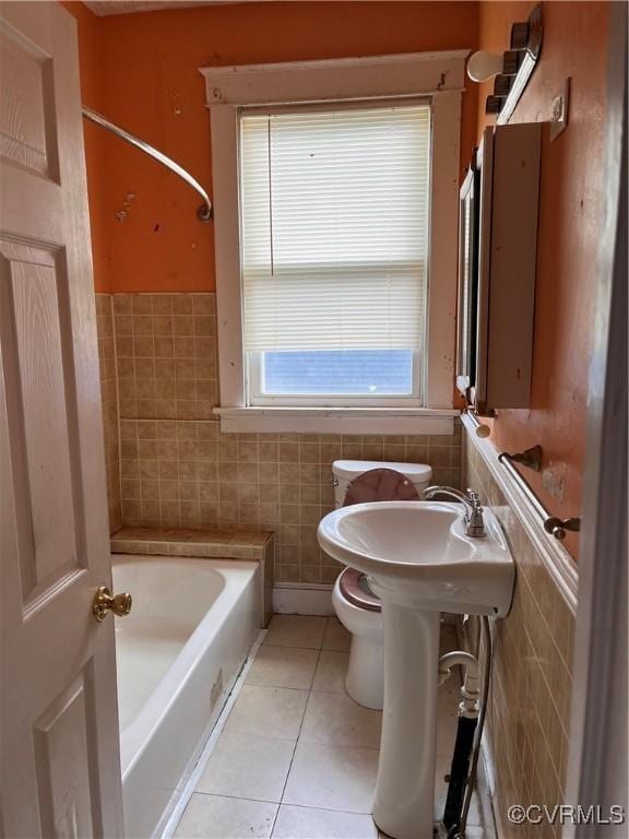 2214 2nd Ave, Richmond, VA 23222 - full bathroom with tile patterned floors, tile walls, and wainscoting