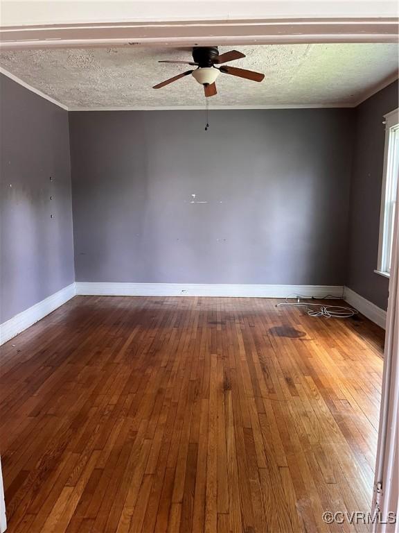 2214 2nd Ave, Richmond, VA 23222 - empty room with wood-type flooring, a ceiling fan, a textured ceiling, and ornamental molding