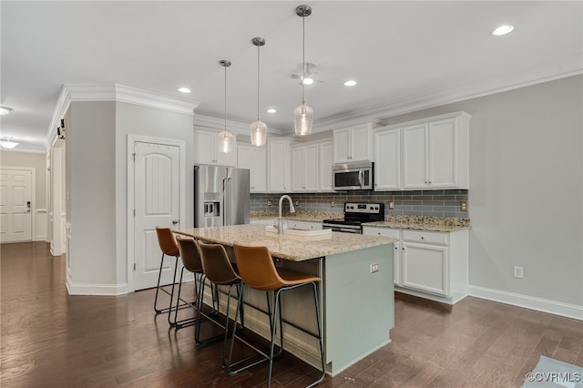 8307 Blackrail Pl, Chesterfield, VA 23832 - kitchen with stainless steel appliances, crown molding, white cabinetry, decorative backsplash, and a kitchen bar