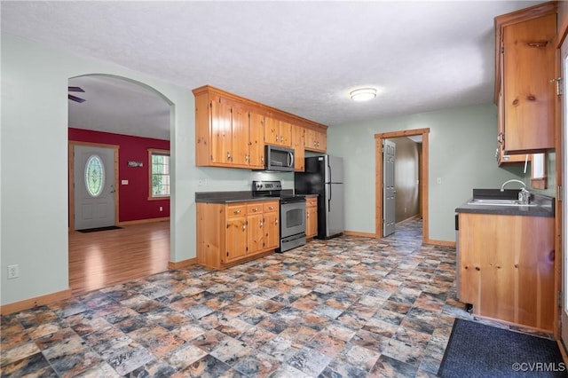 14560 Meade Rd, Amelia, VA 23002 - kitchen featuring stainless steel appliances, dark countertops, and arched walkways