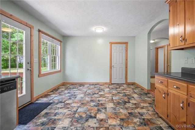 14560 Meade Rd, Amelia, VA 23002 - kitchen with dishwasher, dark countertops, arched walkways, and stone finish floors