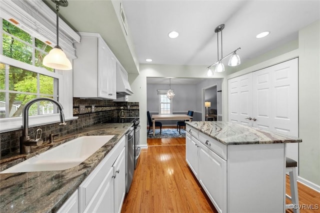 4709 Tameo Ct, Glen Allen, VA 23060 - kitchen with decorative backsplash, light wood-type flooring, white cabinetry, a kitchen island, and recessed lighting