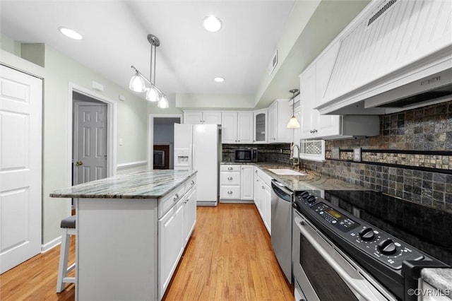 4709 Tameo Ct, Glen Allen, VA 23060 - kitchen with stainless steel appliances, custom range hood, white cabinets, tasteful backsplash, and recessed lighting